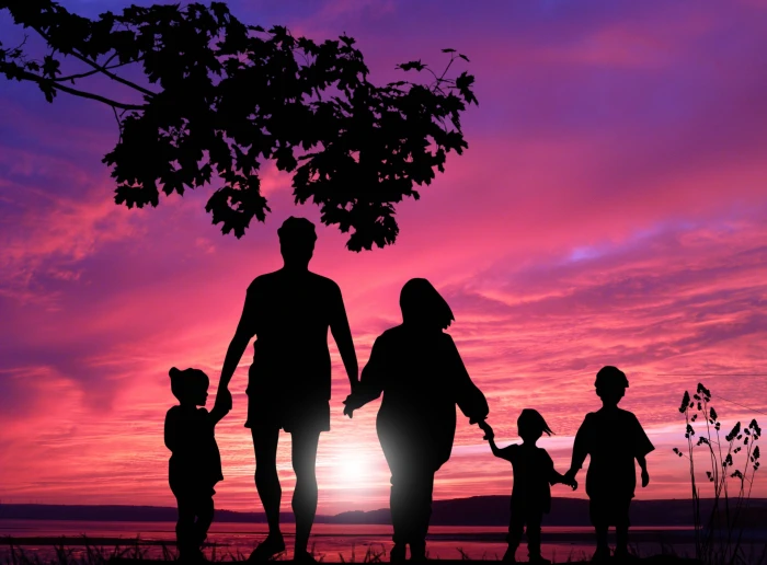 Happy family walking into the sunset